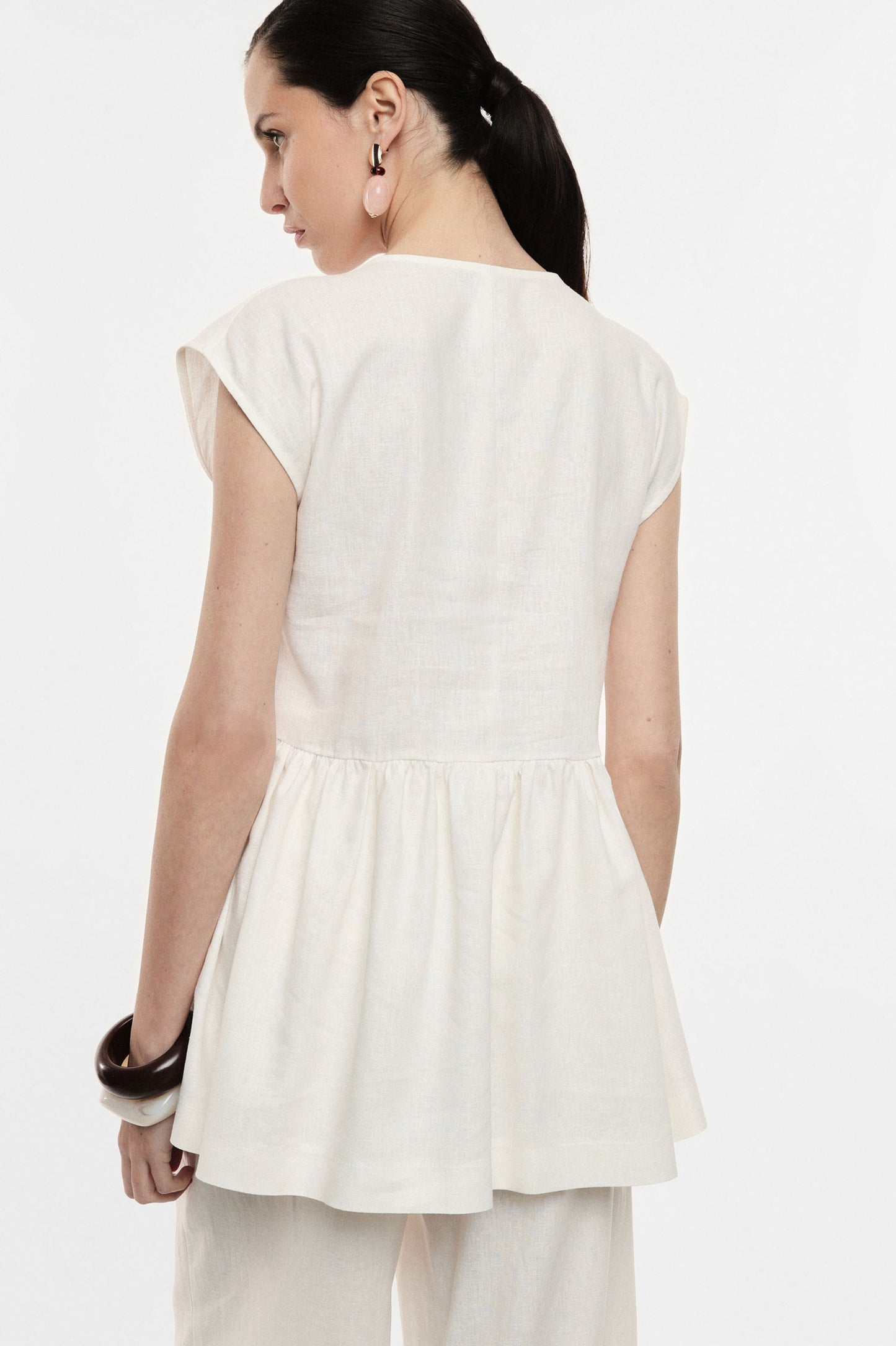 Long vest with central single button fastening