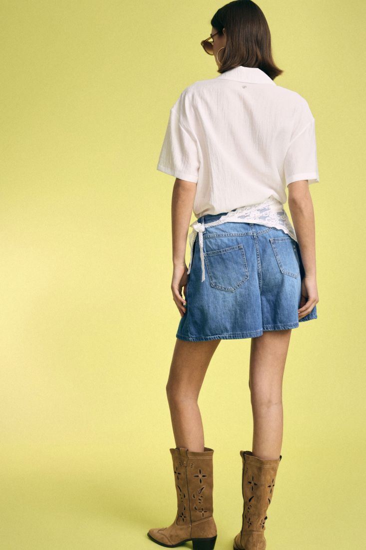 Denim skorts with asymmetric lace accent