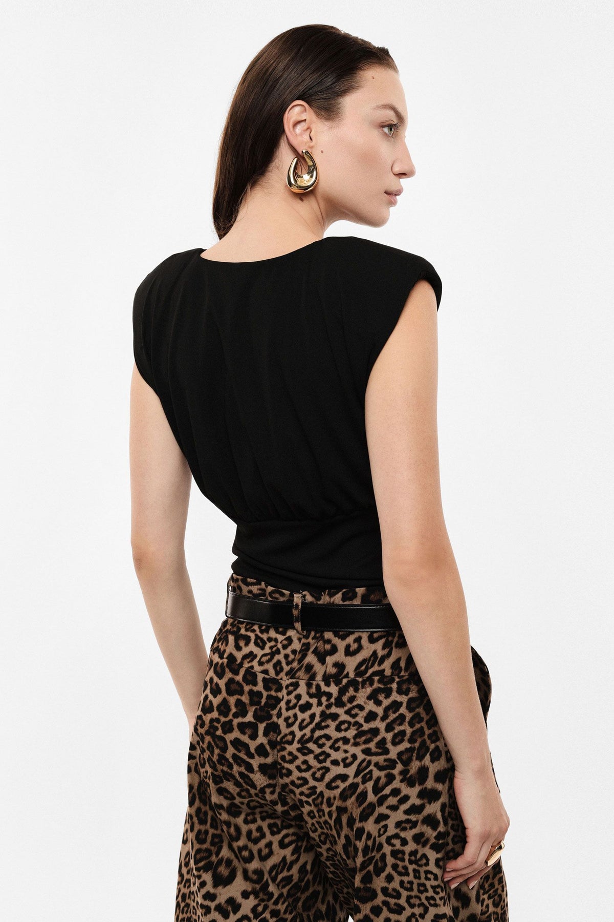 Sleeveless bodysuit with structured shoulders