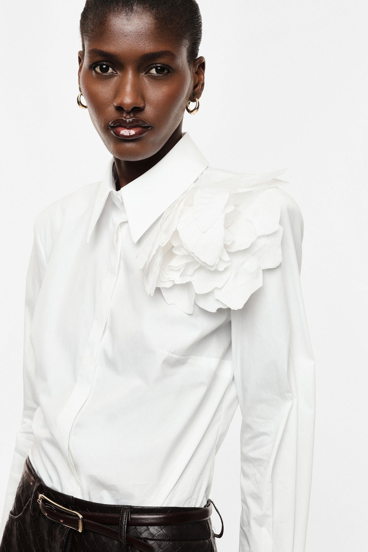 Shirt with flower appliqué and extended cuffs