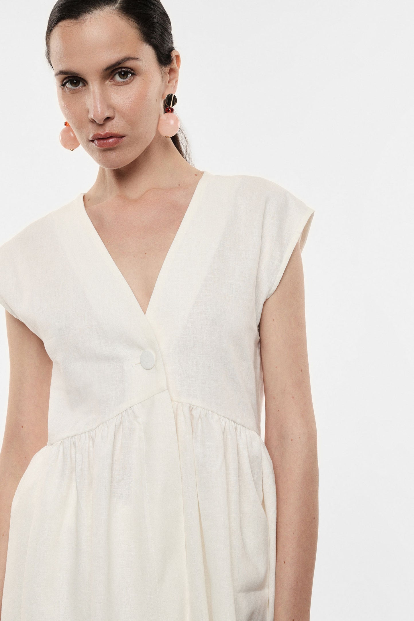 Long vest with central single button fastening
