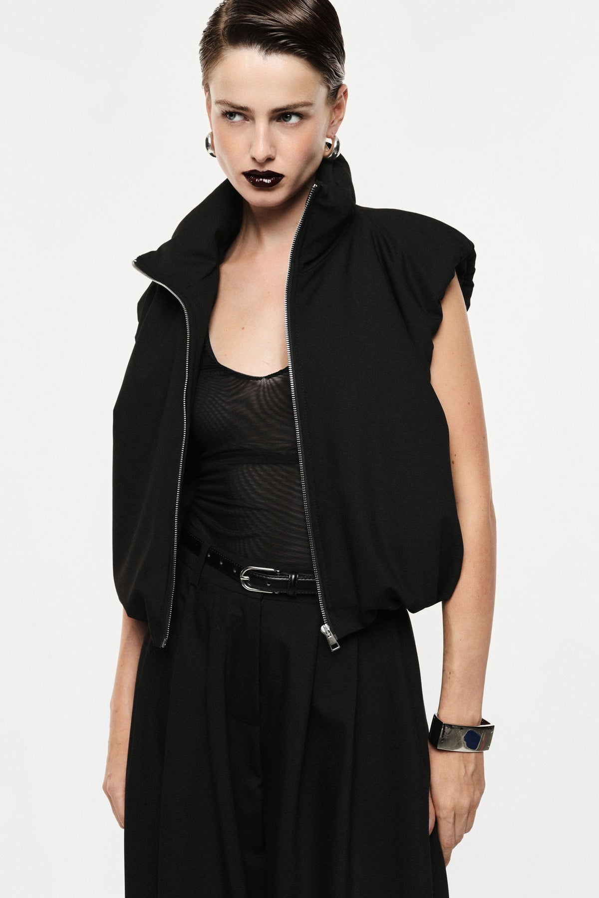 Sleeveless jacket with zip closure and high collar