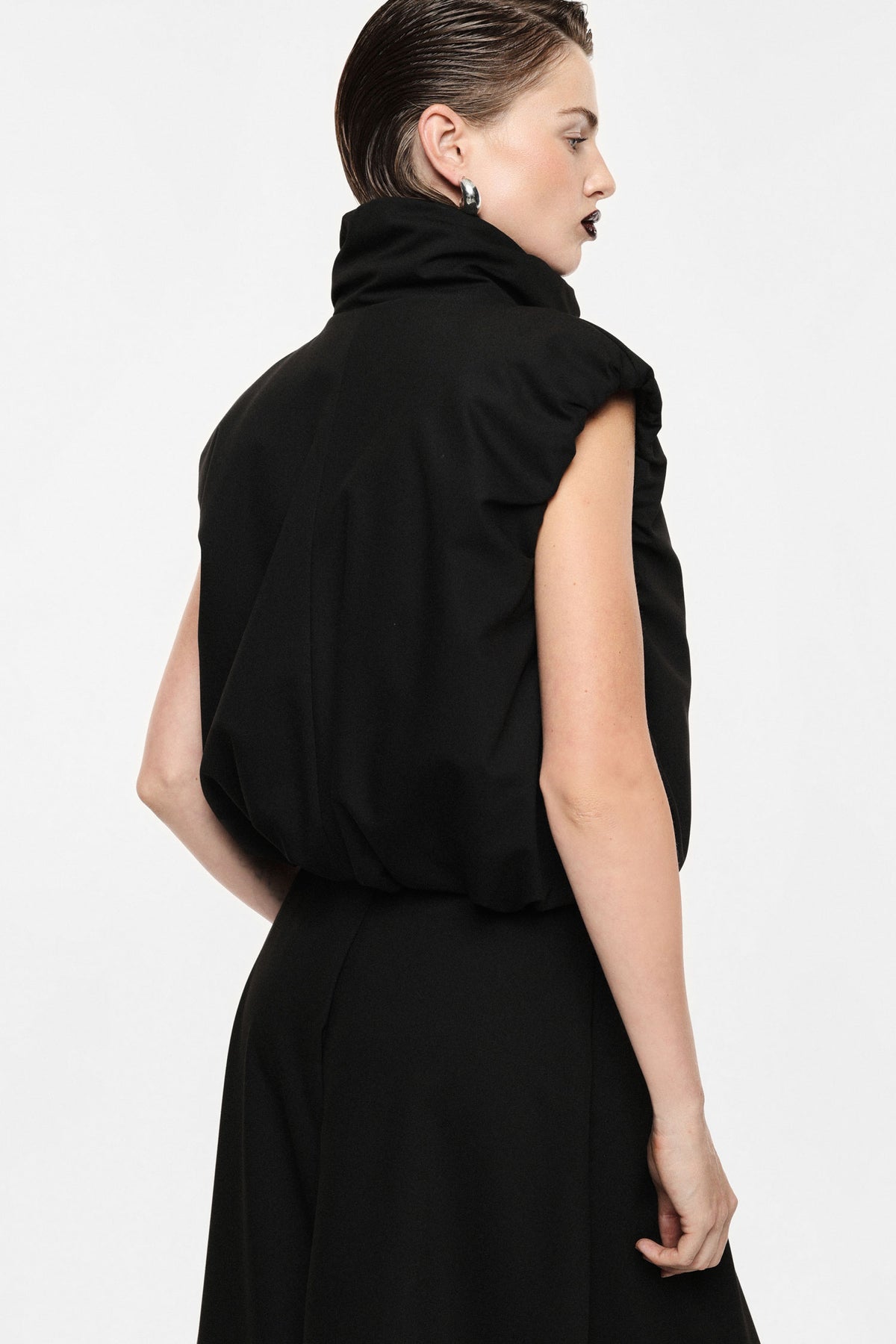 Sleeveless jacket with zip closure and high collar