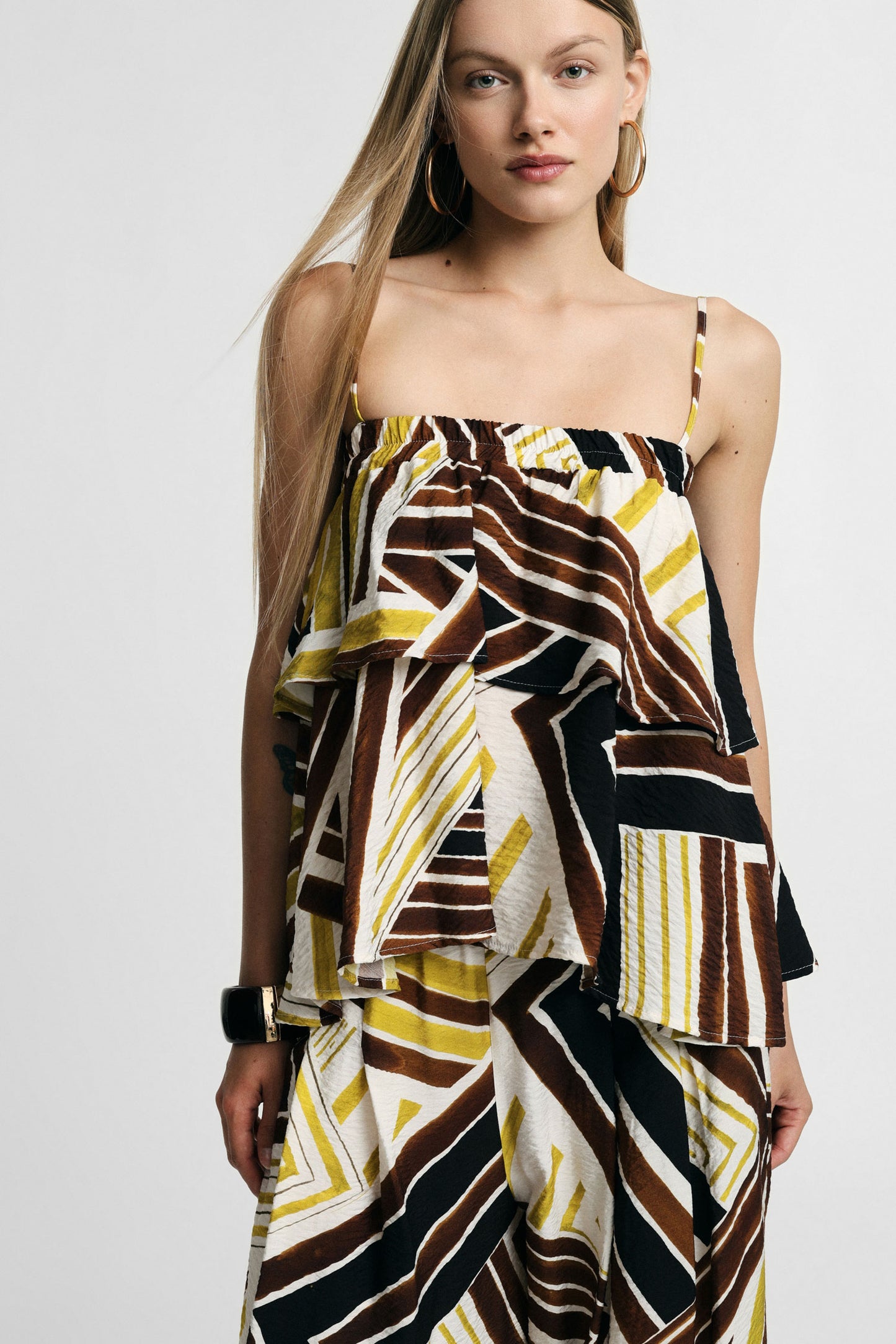 Top with straps and asymmetrical geometric print